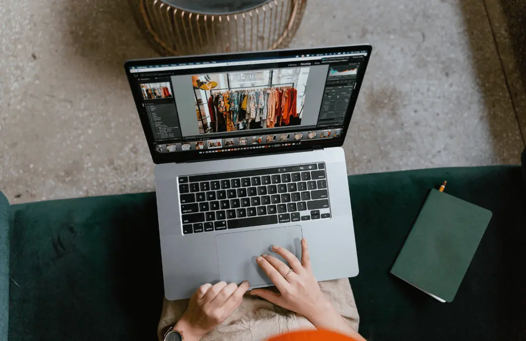 A top down view of a woman editing photos on her laptop