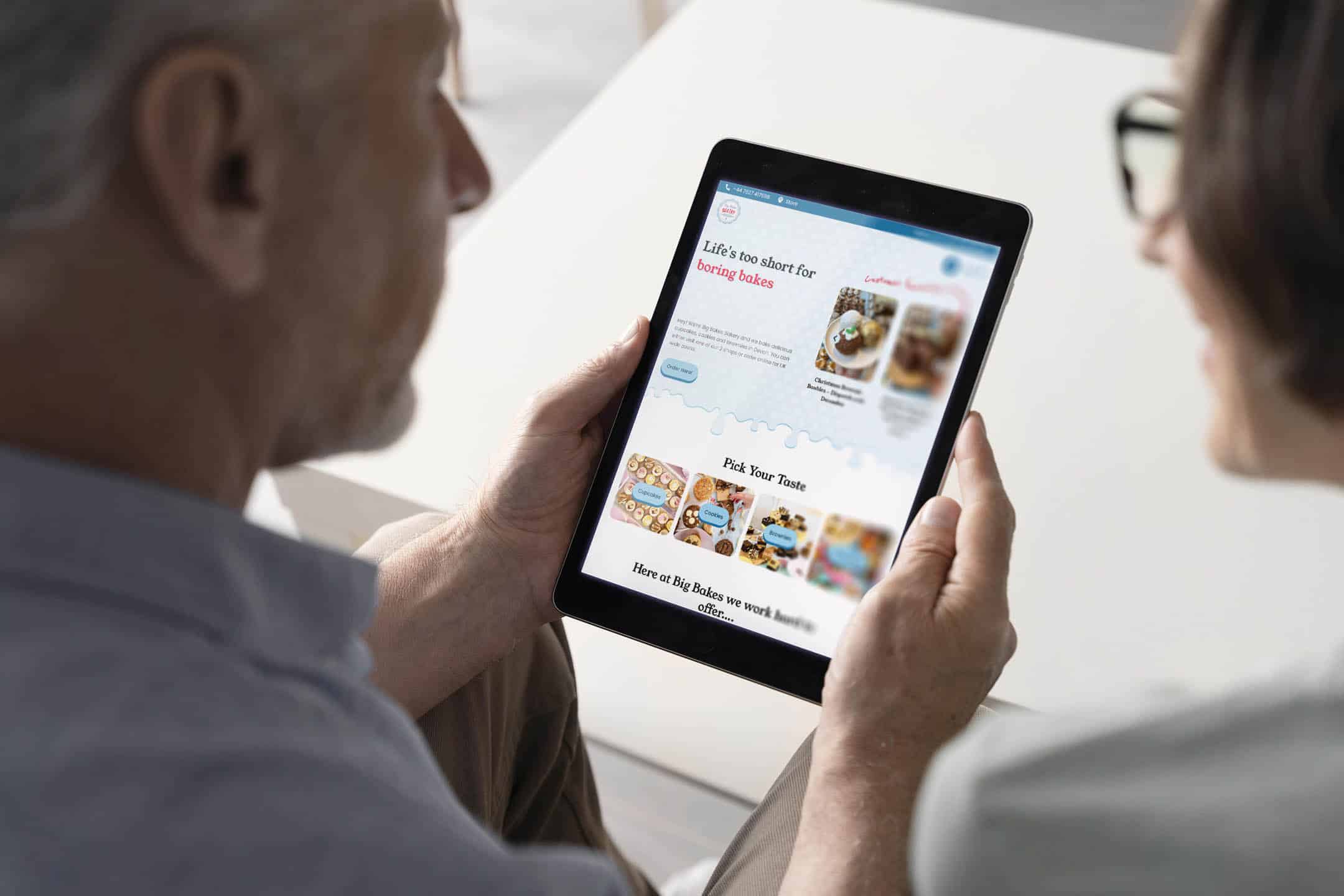 A couple browsing the Big Bakes Bakery website on their tablet