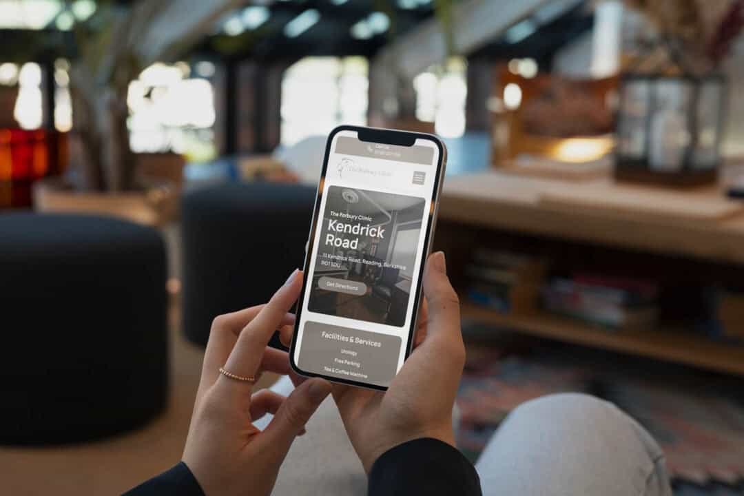A smartphone user browsing The Forbury Clinic website