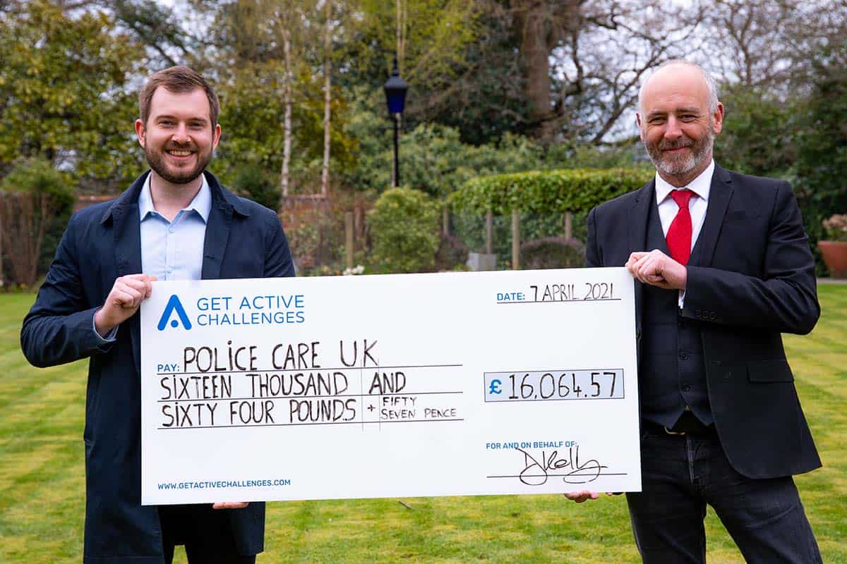 E-Innovate founder Karim with a representative of Police Care UK, presenting a cheque