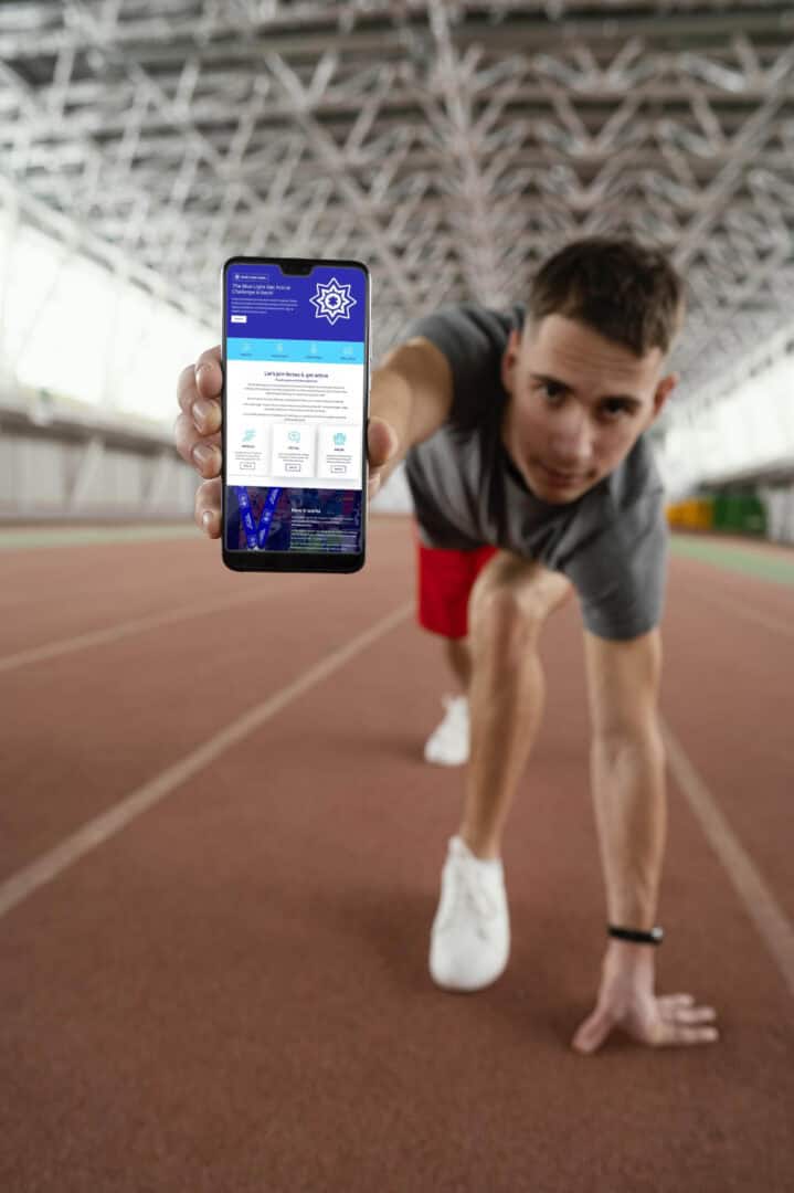 A runner holding a smartphone displaying the Get Active Challenges website