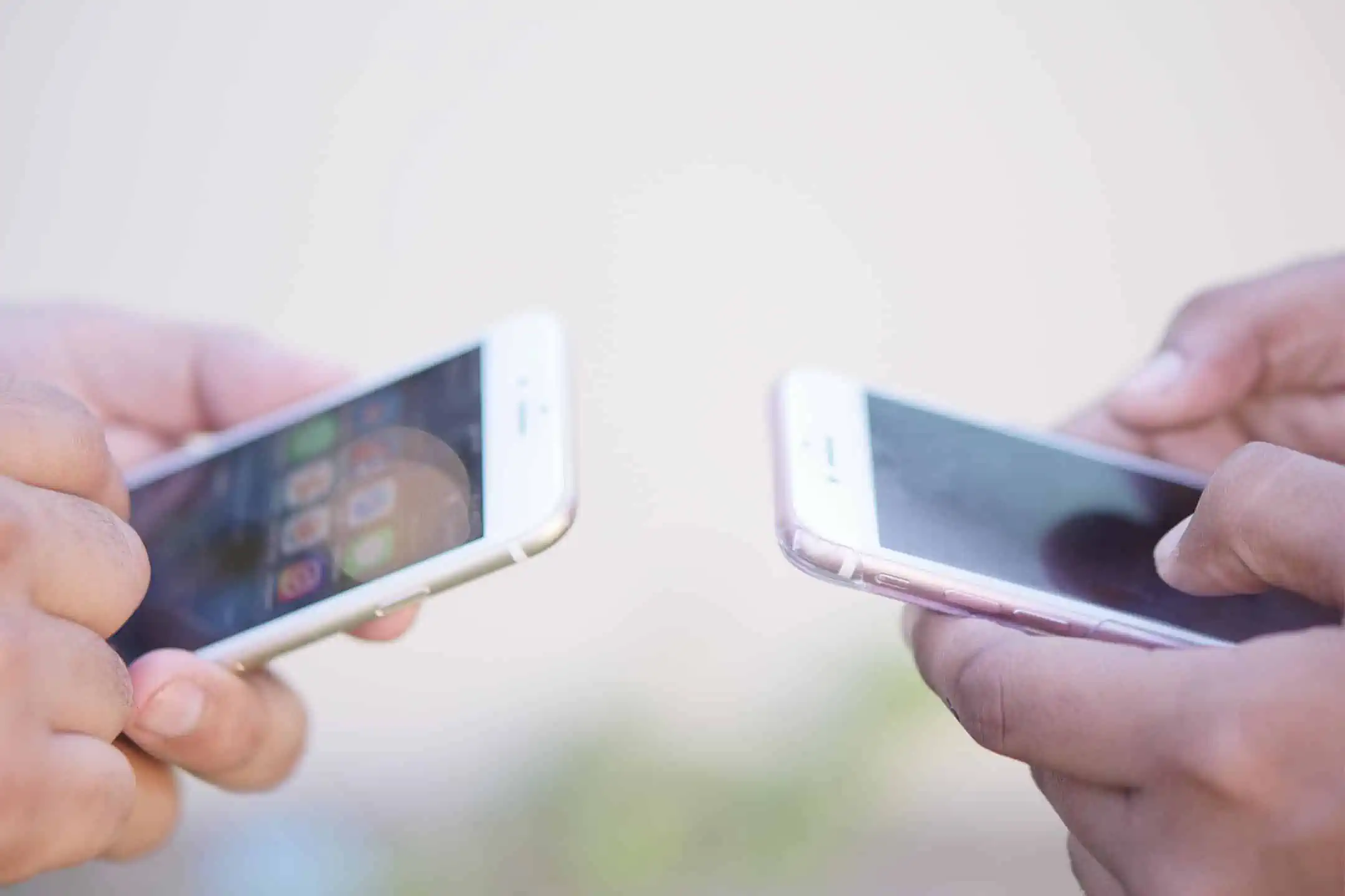 Two smartphone users on their phones